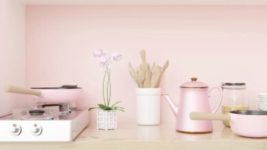 a kitchen with pink walls and a stove