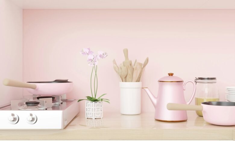 a kitchen with pink walls and a stove