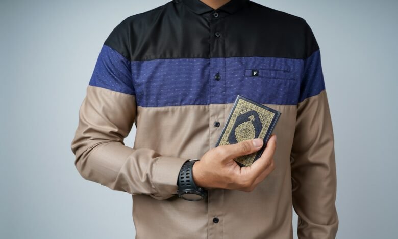 man in brown button up shirt holding 1 us dollar bill