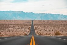 long exposure photography of black concrete road on open area during daytime