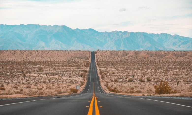 long exposure photography of black concrete road on open area during daytime